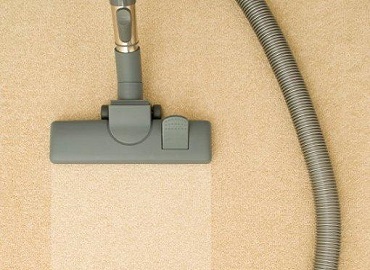 Vacuum cleaner on beige carpet